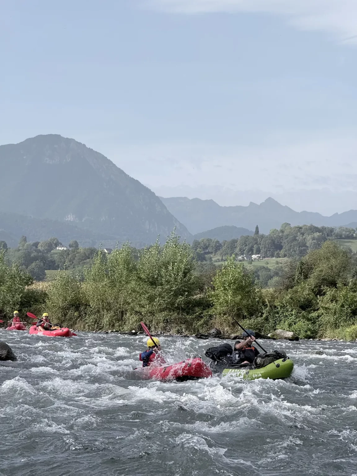 Packrafts dans un rapide du gave de Pau à Bétharram, face aux montagnes des Pyrénées